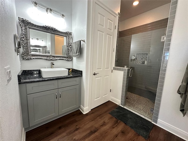 bathroom with vanity, hardwood / wood-style floors, and walk in shower