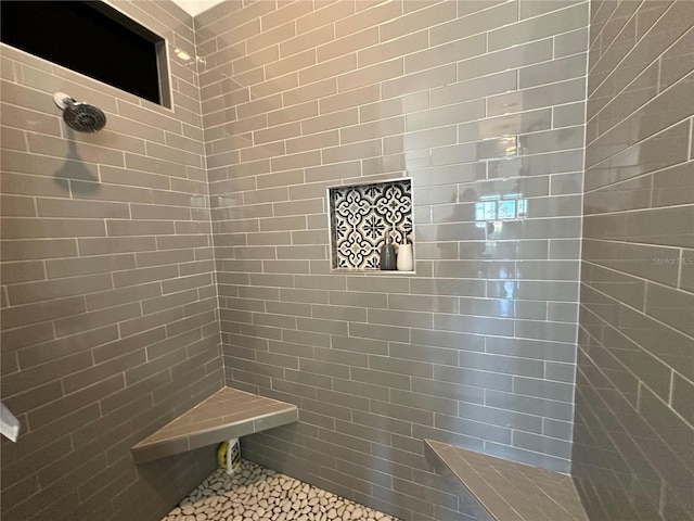 bathroom with tiled shower