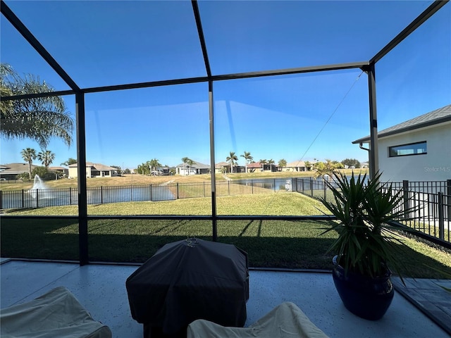 unfurnished sunroom with a water view