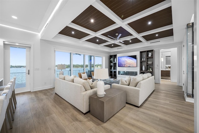 living room featuring wood ceiling, a water view, light wood-type flooring, beam ceiling, and coffered ceiling