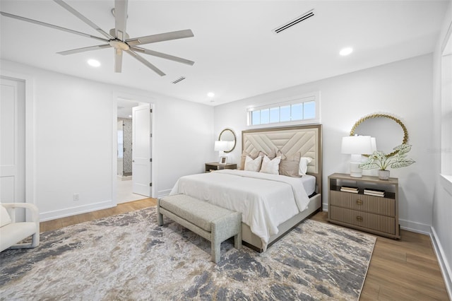 bedroom featuring dark hardwood / wood-style floors, connected bathroom, and ceiling fan