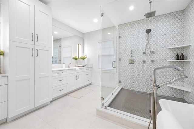 bathroom featuring walk in shower, vanity, and tile patterned flooring