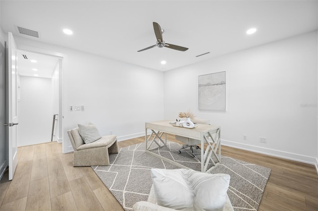 home office featuring hardwood / wood-style floors and ceiling fan