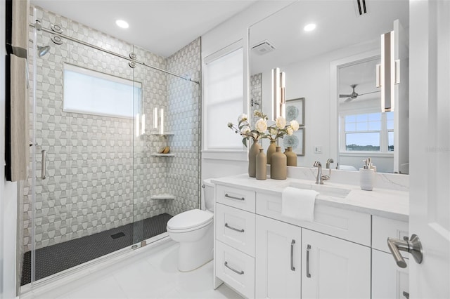 bathroom featuring vanity, toilet, and a shower with door