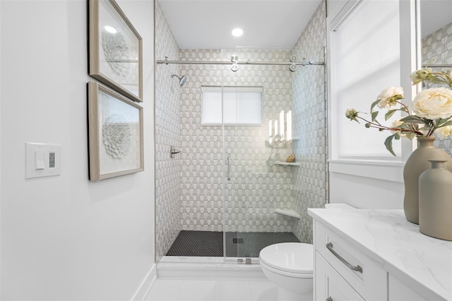 bathroom featuring tile patterned floors, a wealth of natural light, toilet, and vanity