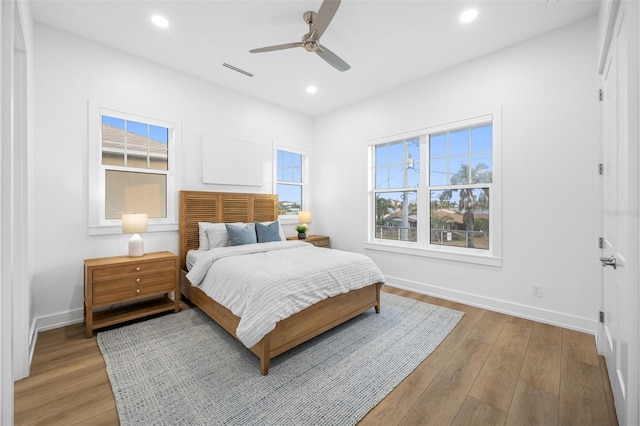 bedroom featuring ceiling fan and light hardwood / wood-style flooring