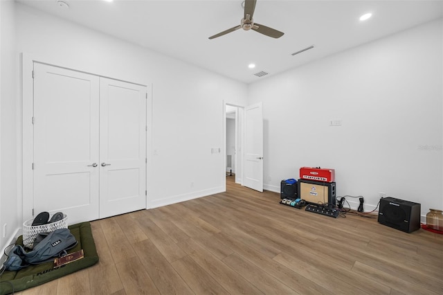 unfurnished bedroom with hardwood / wood-style floors, a closet, and ceiling fan