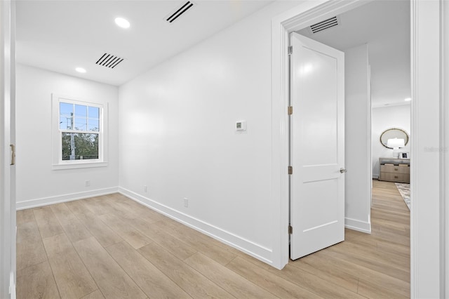 empty room with light hardwood / wood-style flooring