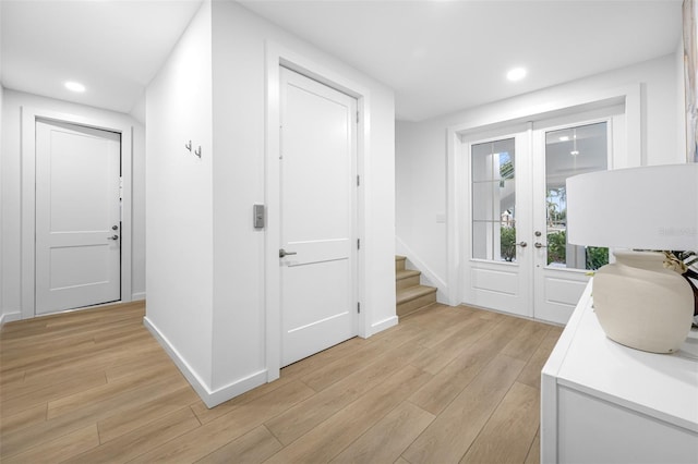 hall featuring light hardwood / wood-style floors and french doors