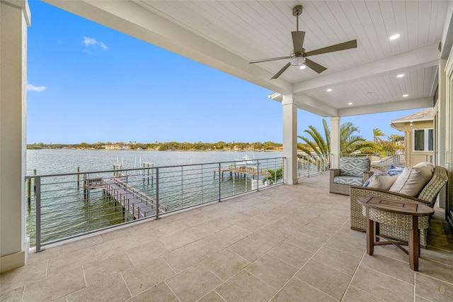 view of patio / terrace with a water view and ceiling fan