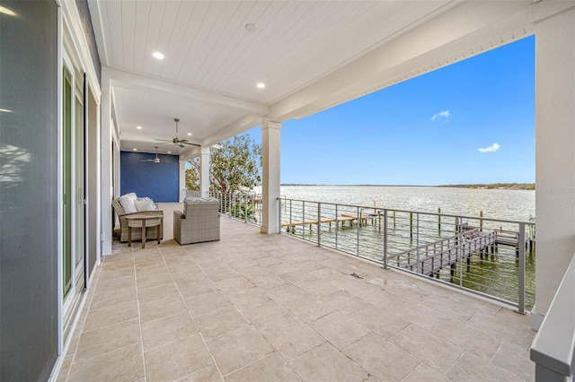 view of patio / terrace with ceiling fan and a water view