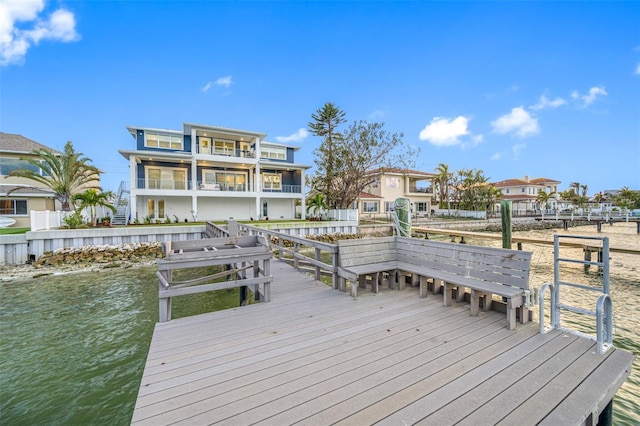 dock area featuring a balcony and a water view