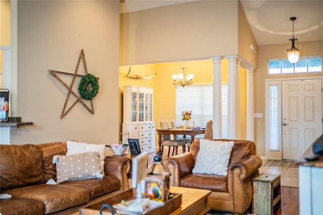 living room with decorative columns, tile patterned floors, and a chandelier