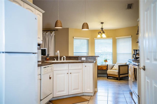 kitchen featuring sink, white appliances, light tile patterned floors, white cabinets, and decorative light fixtures