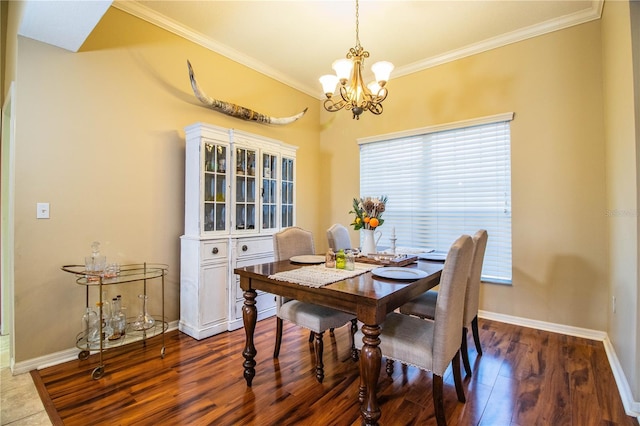 dining space featuring dark hardwood / wood-style flooring, a notable chandelier, and ornamental molding