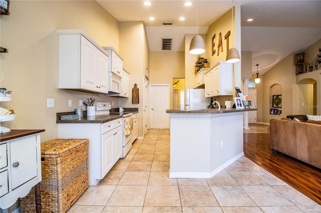 kitchen featuring white cabinetry, light tile patterned floors, kitchen peninsula, pendant lighting, and white appliances