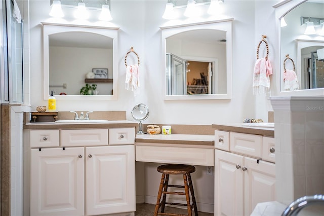 bathroom featuring vanity and a shower with door