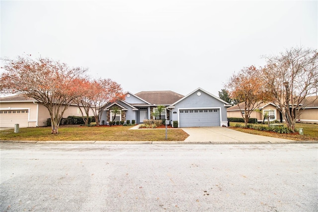 single story home featuring a garage and a front lawn