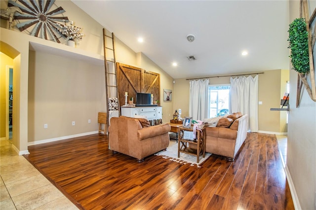 living room featuring baseboards, arched walkways, dark wood-style flooring, recessed lighting, and high vaulted ceiling