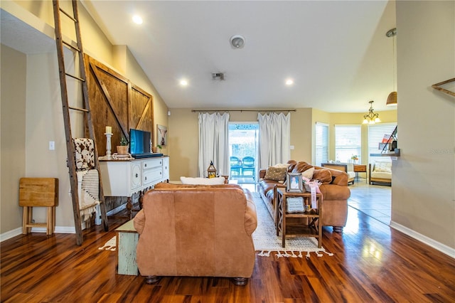 living area with a wealth of natural light, dark wood-style floors, vaulted ceiling, and a chandelier