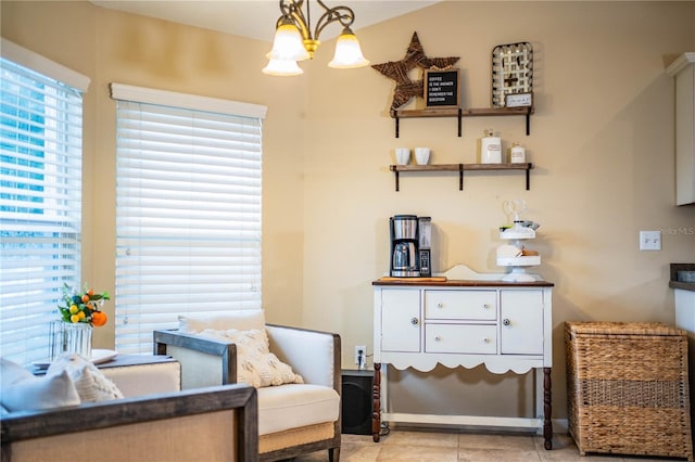 living area featuring a wealth of natural light, a chandelier, and light tile patterned flooring