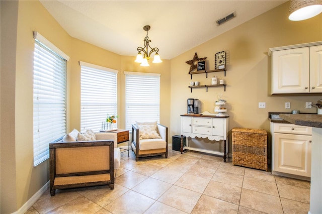 sitting room featuring a chandelier, plenty of natural light, visible vents, and baseboards