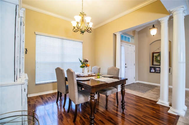 dining space with baseboards, a chandelier, dark wood finished floors, crown molding, and ornate columns