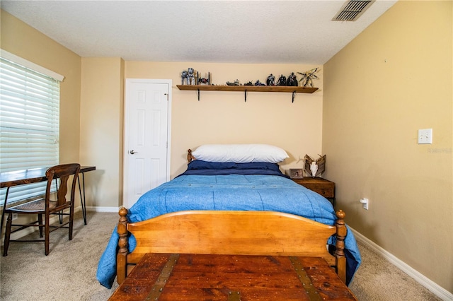 carpeted bedroom featuring visible vents and baseboards