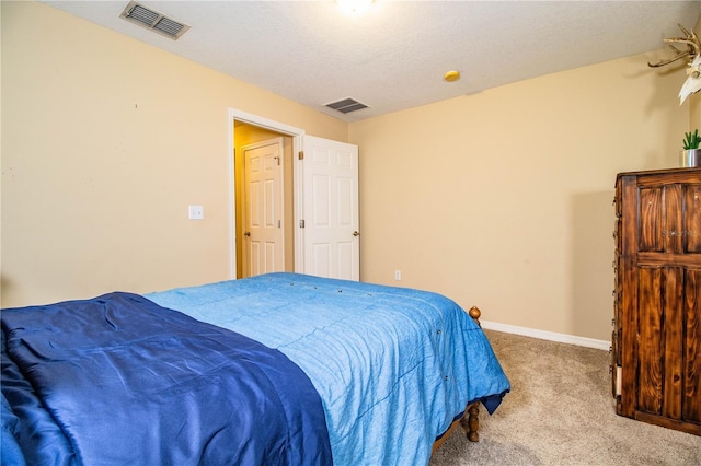bedroom featuring visible vents, baseboards, a textured ceiling, and carpet floors