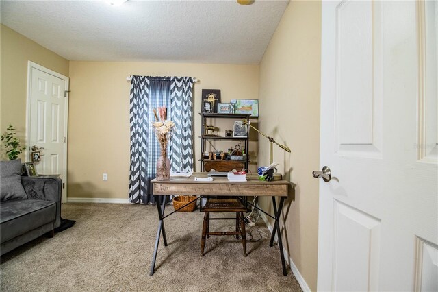 home office with a textured ceiling, carpet flooring, and baseboards