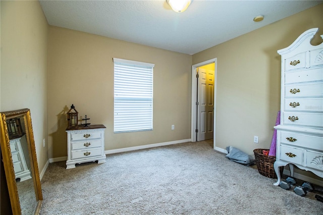 unfurnished bedroom with carpet flooring and baseboards