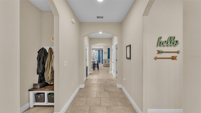 corridor featuring light tile patterned floors