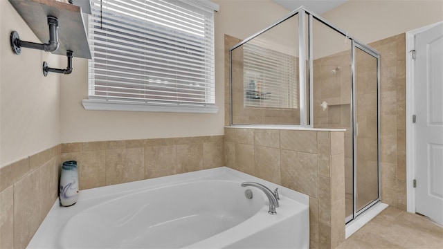 bathroom featuring independent shower and bath and tile patterned flooring