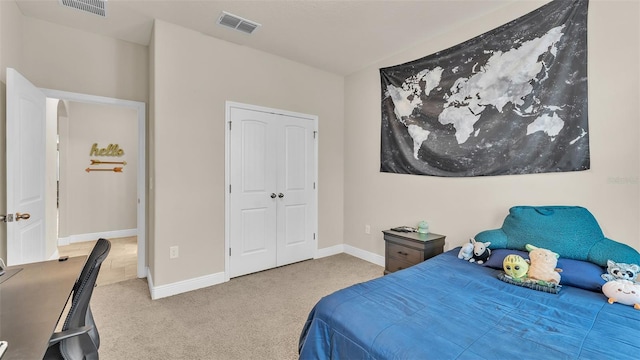 bedroom featuring light colored carpet and a closet