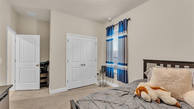 carpeted bedroom featuring a closet