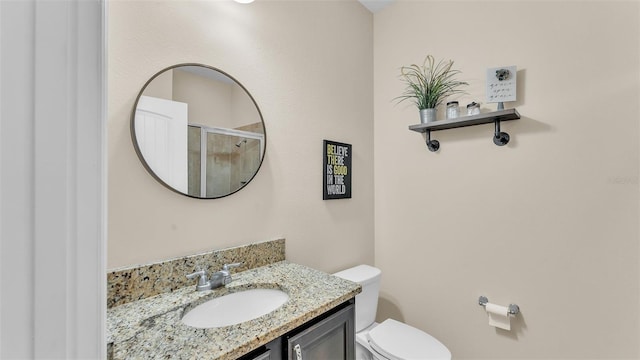 bathroom with vanity, toilet, and an enclosed shower