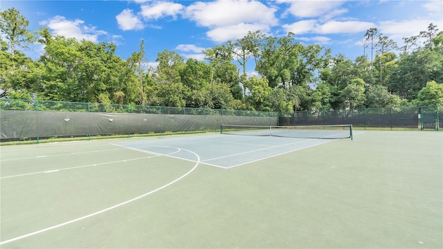 view of tennis court with basketball hoop