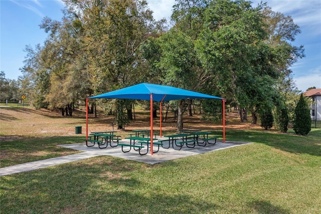 view of community with a patio area and a lawn