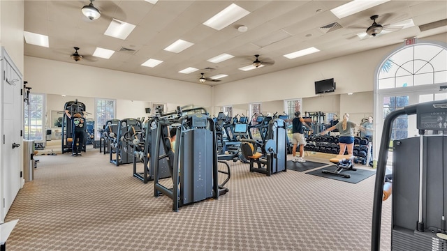 workout area featuring light carpet and ceiling fan