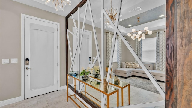 living room featuring a chandelier and light tile patterned floors