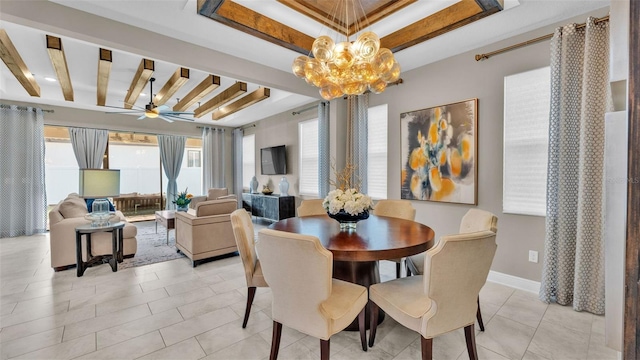 tiled dining room with a tray ceiling and ceiling fan with notable chandelier