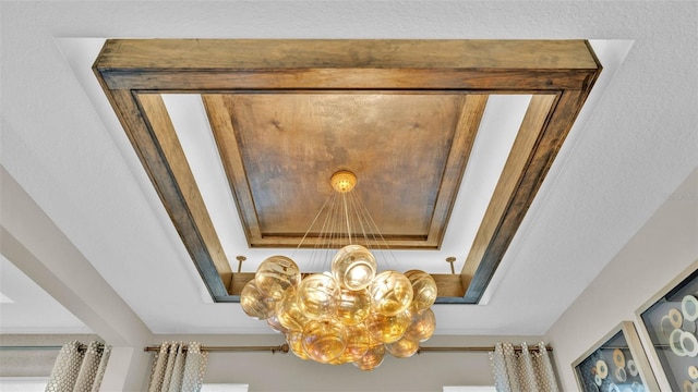 interior details featuring a chandelier