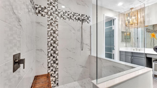 bathroom with vanity and a tile shower