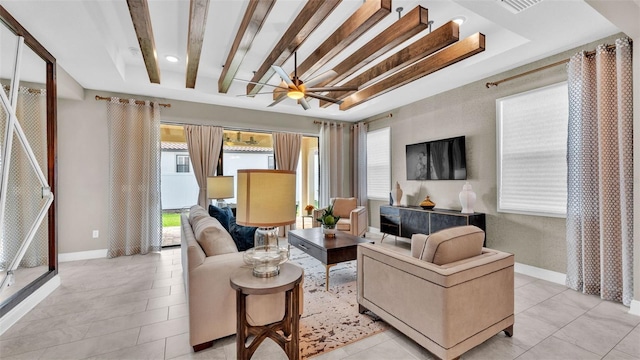 tiled living room featuring beam ceiling, a raised ceiling, and ceiling fan