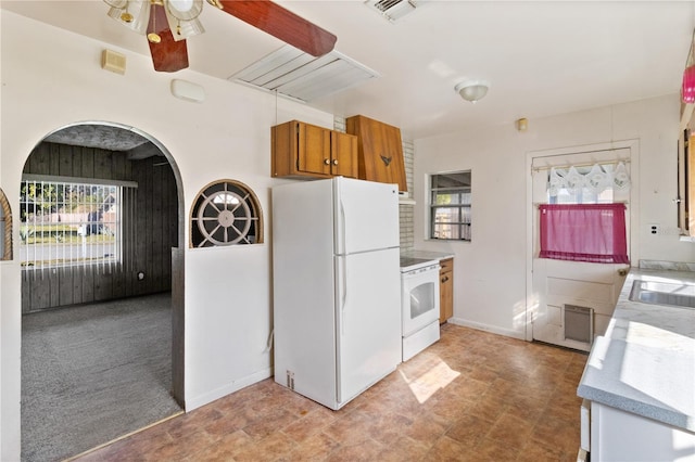 kitchen with ceiling fan, white appliances, plenty of natural light, and sink