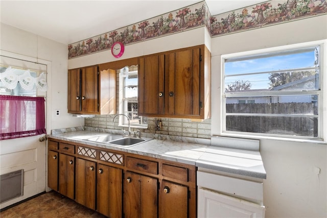 kitchen with tasteful backsplash, sink, and a wealth of natural light