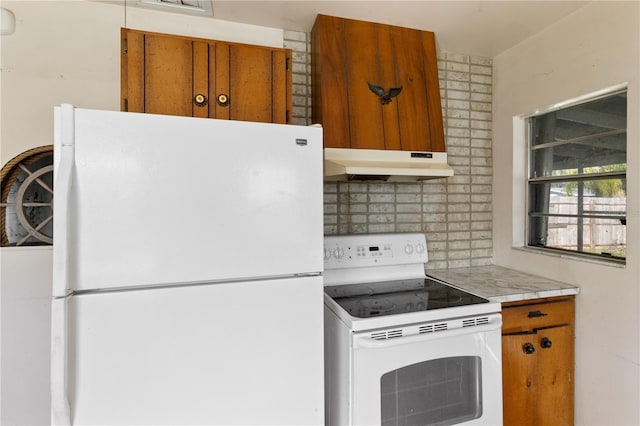 kitchen with white appliances and decorative backsplash