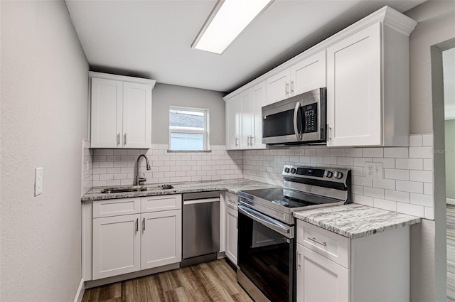 kitchen featuring sink, white cabinetry, and appliances with stainless steel finishes