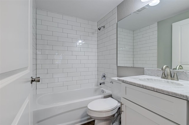 full bathroom featuring vanity, toilet, and tiled shower / bath combo