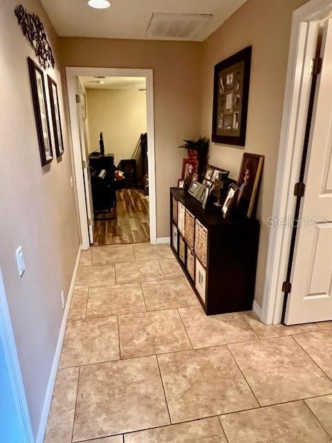 hallway with light tile patterned floors